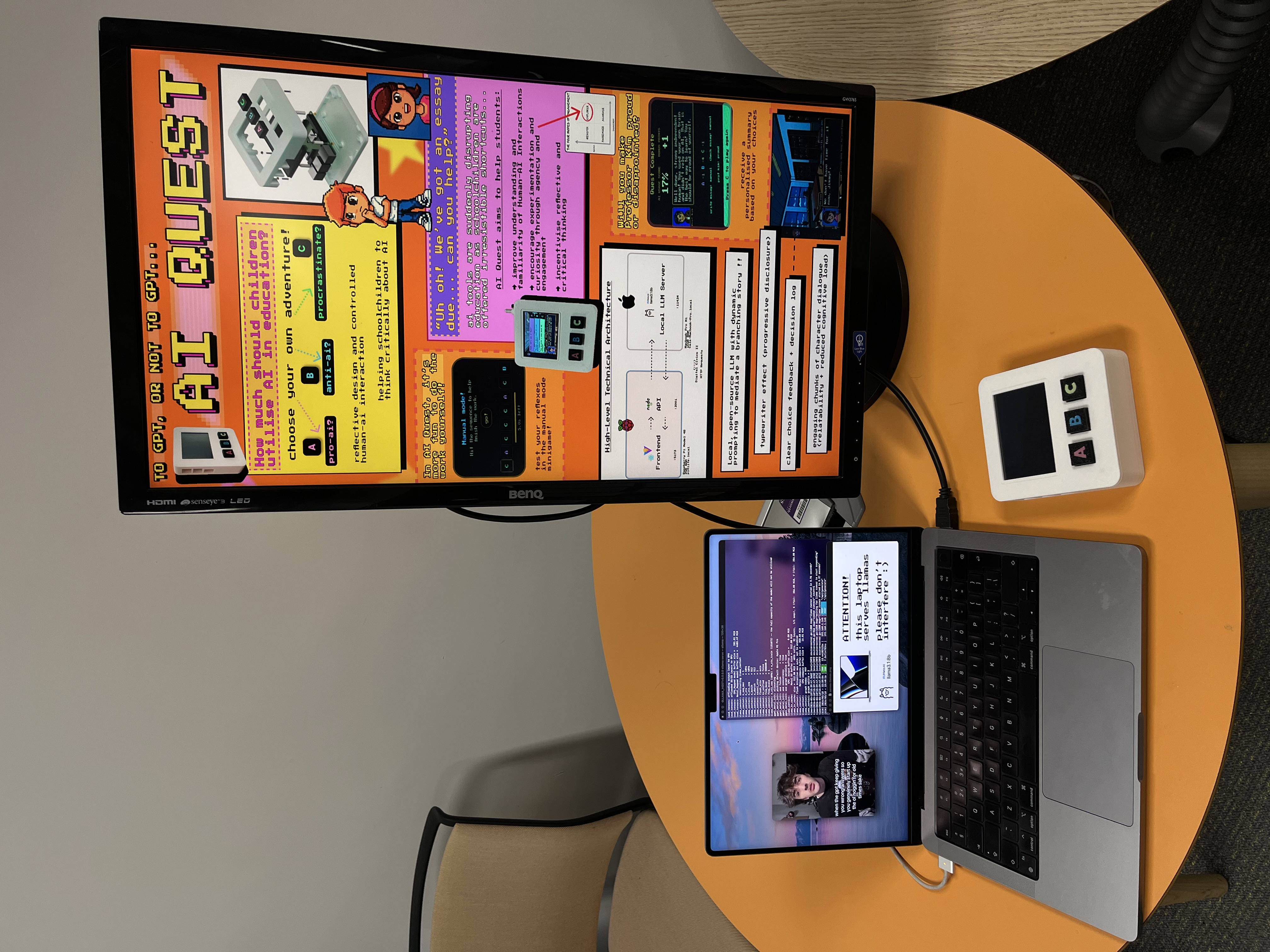 The AI Quest demo desk setup prepared for Open Lab visitors: console, technical architecture diagram, and supporting materials